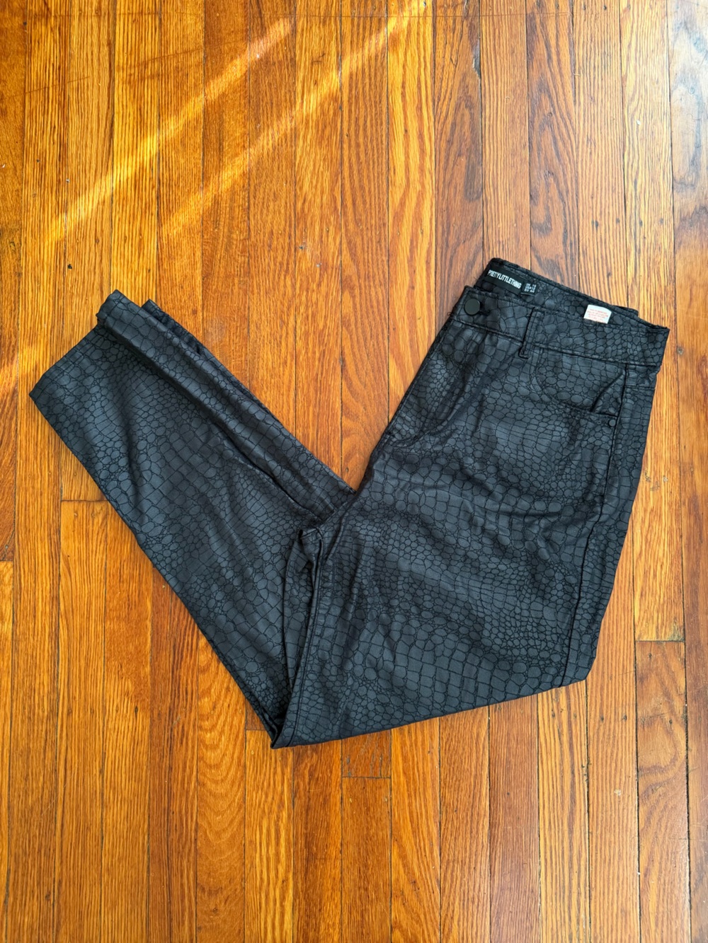 Black croc or snake print pants